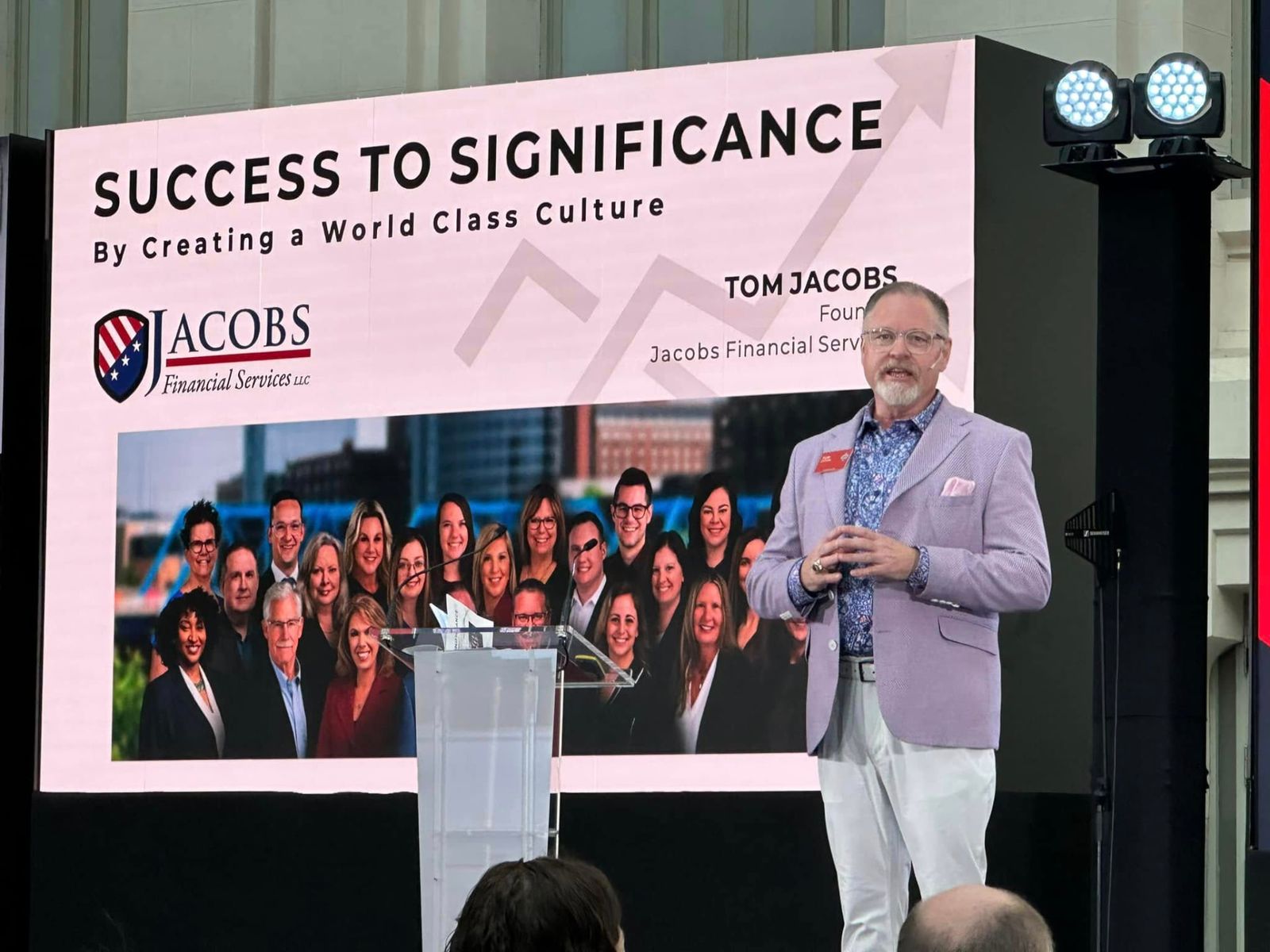 Tom Jacobs presenting Success To Significance on stage to a room of advisors